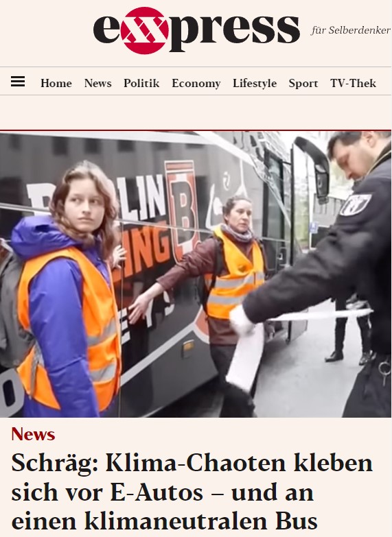 Schräg: Klima-Chaoten kleben sich vor E-Autos – und an einen klimaneutralen Bus
